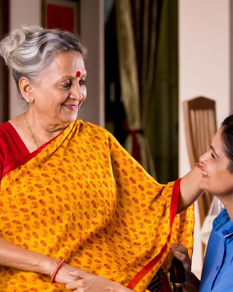 A Naetrika caregiver supporting a senior at home